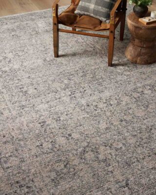 Wooden chair on textured gray carpet in cozy room setting.